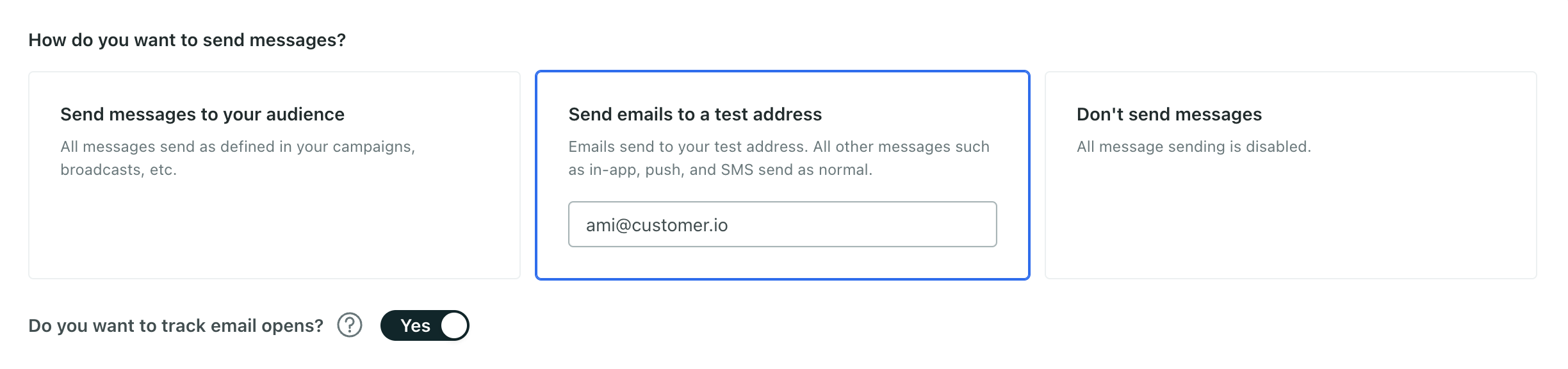 An image of the middle of general workspace settings. The section is titled: How do you want to send messages? There are three options from left to right. On the left is: send messages normally. In the middle is: send emails to a test address. On the right is: never send messages. Send emails to a test address is selected and highlighted in blue. There is a dropdown field where the email address ami@customer.io is selected.